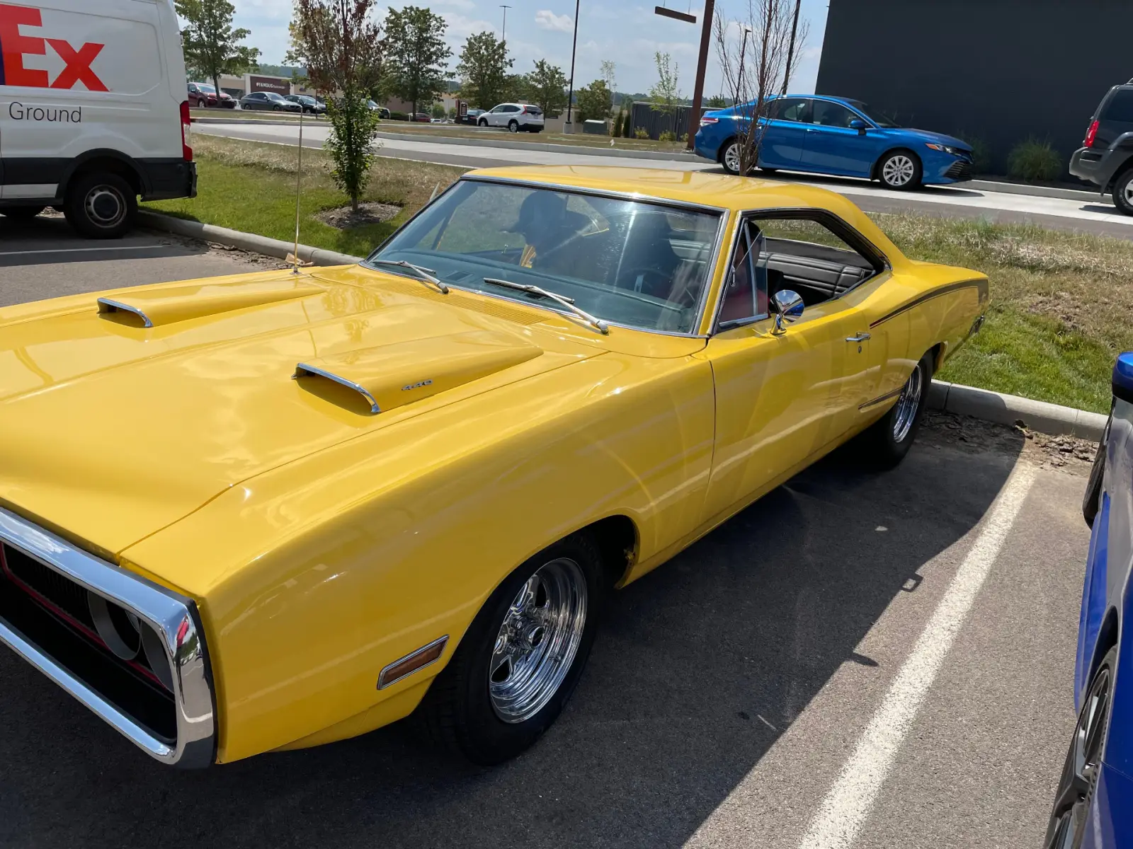 Yellow classic muscle car with hood scoops serviced at Pitt Stop Tire & Auto in Xenia, OH